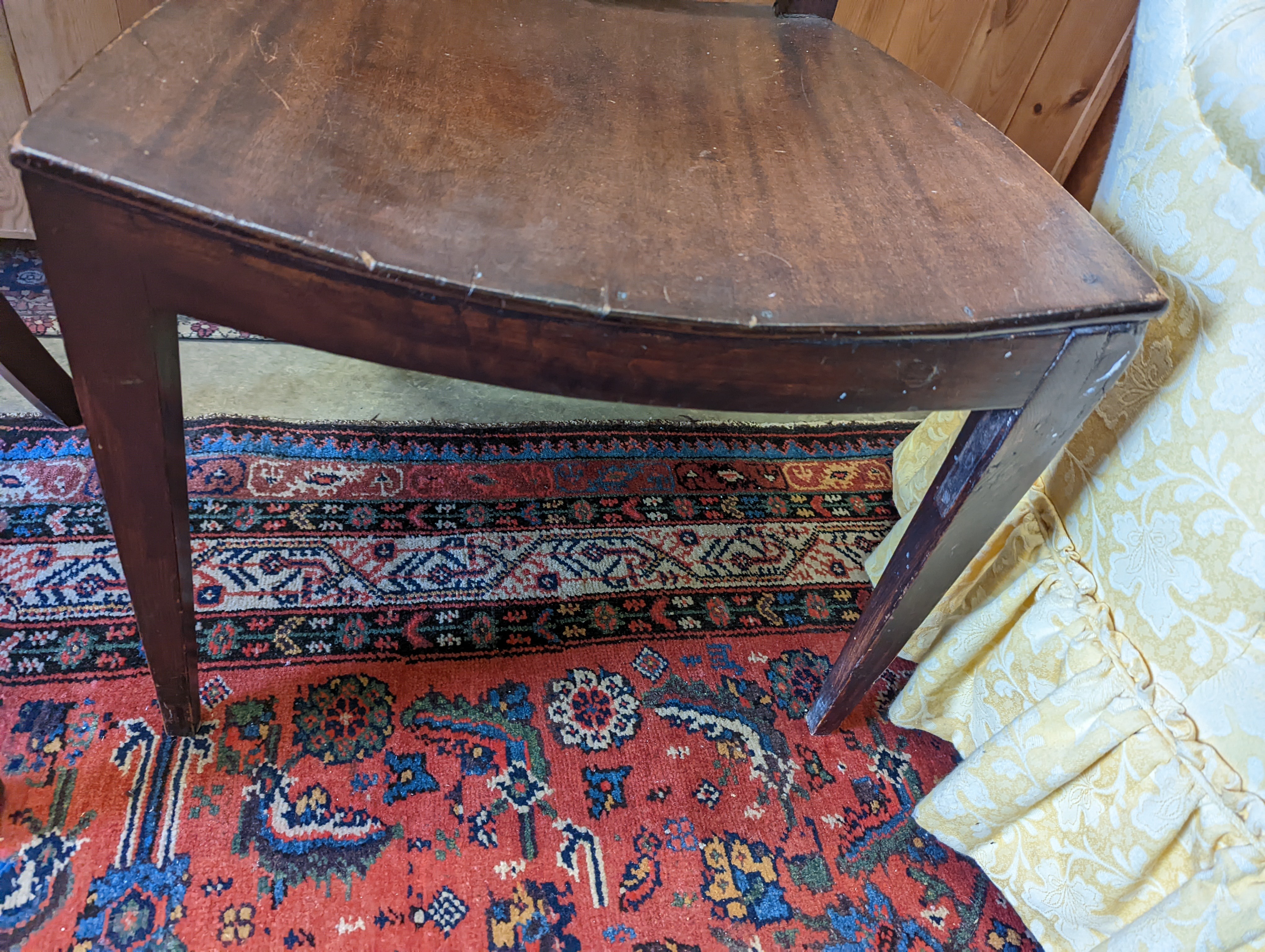 A brown leather upholstered desk chair, a mahogany hall chair and two upholstered armchairs